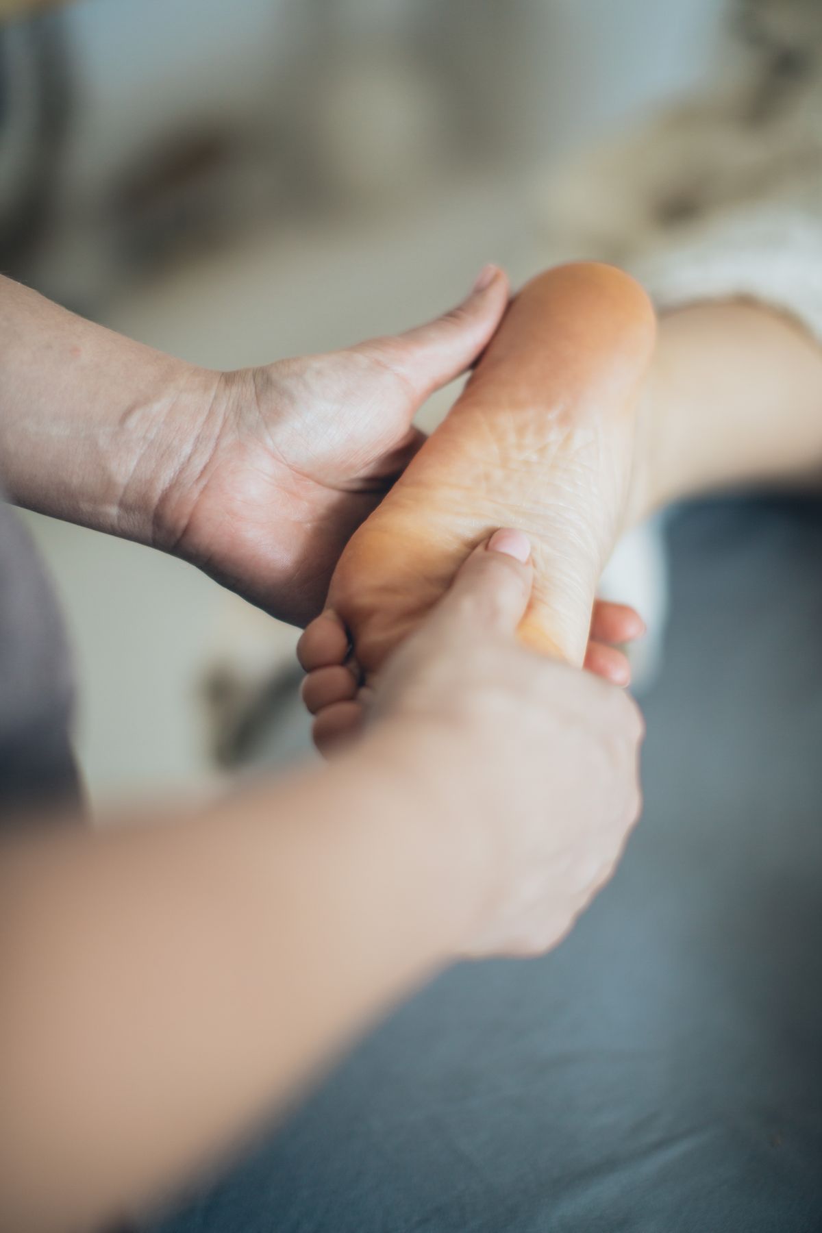 Mains soutenant délicatement un pied pendant un soin